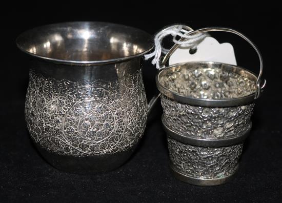 An Indian white metal small cup and cream pail.